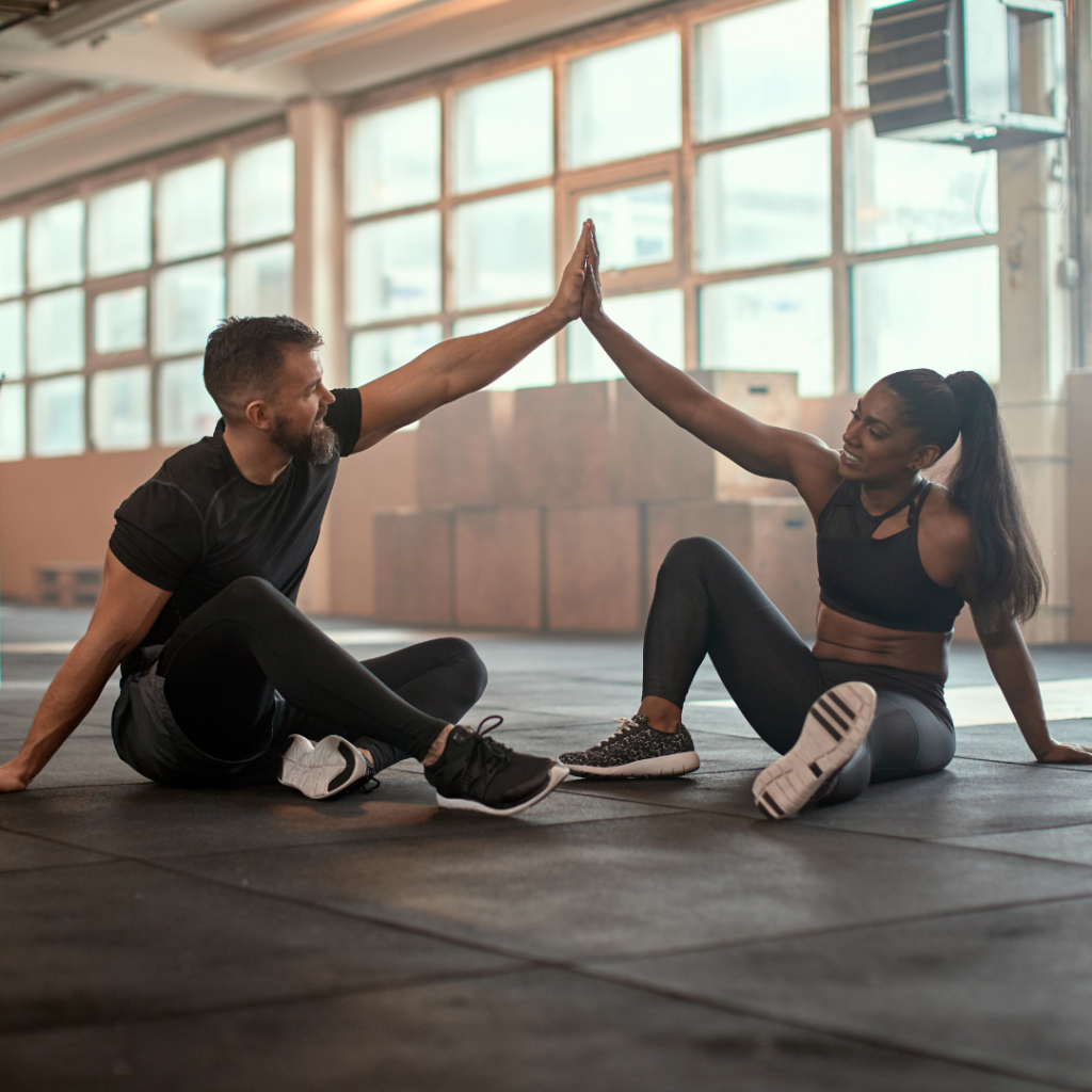 training partners high fiving each other